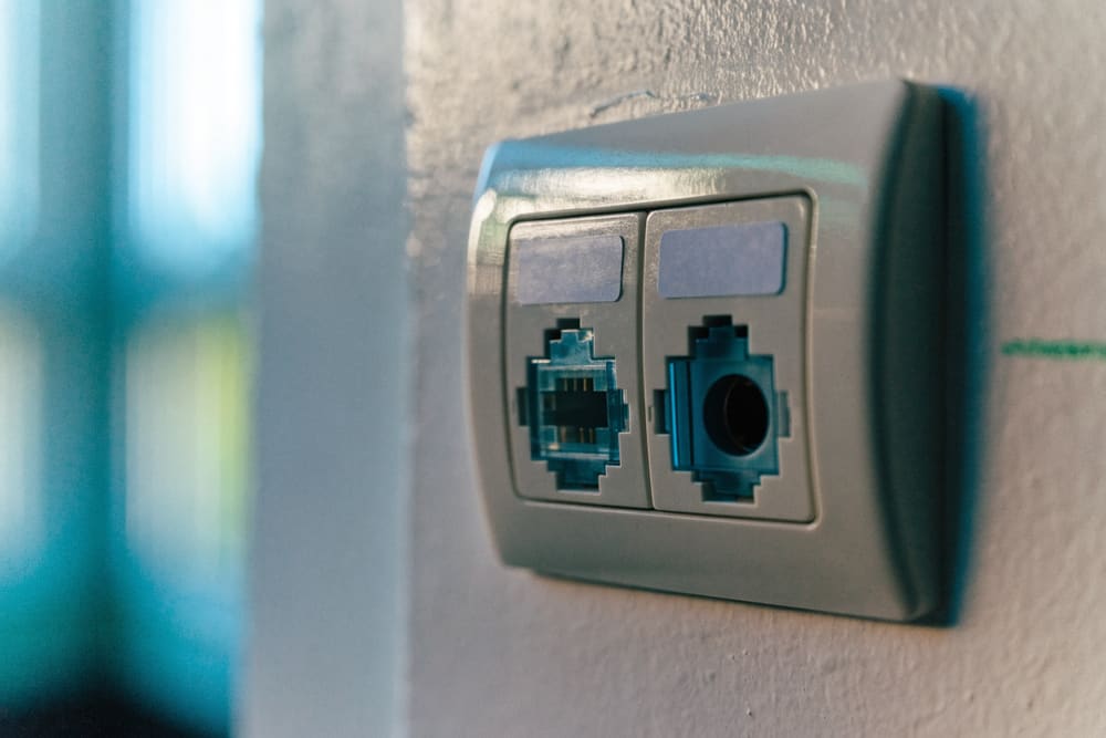 A finished flush wall plate with two labeled keystone jacks seated cleanly in it.
